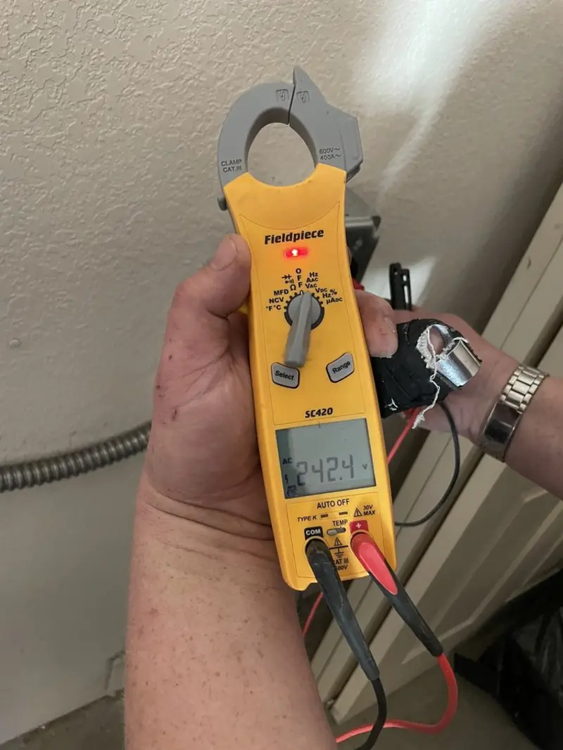Voltage testing with clamp meter during Recessed Lighting Installation in Lake Station